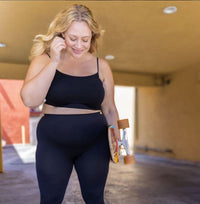 Woman standing holding a skateboard wearing Black Plus Bralette with Basic Leggings