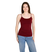 A woman modeling a sleeveless, scoop-neck camisole in cranberry, paired with light-wash blue jeans, against a plain white background.