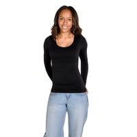 A woman modeling a black long-sleeve scoop-neck top paired with light blue jeans, standing against a solid white background.
