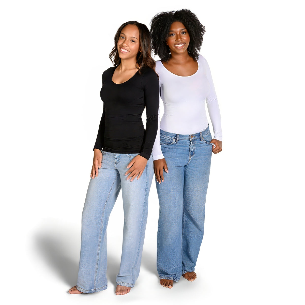Two women modeling long-sleeve, scoop neck, fitted tops in black and white tops, standing barefoot against a white studio background.
