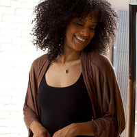 Woman standing wearing a Black Basic Tank Top with taupe Cocoon cardigan