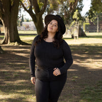 Black Plus Sparkle Long Sleeve Crew Neck Top Girl Outside Wearing Black Jeans and Black Hate