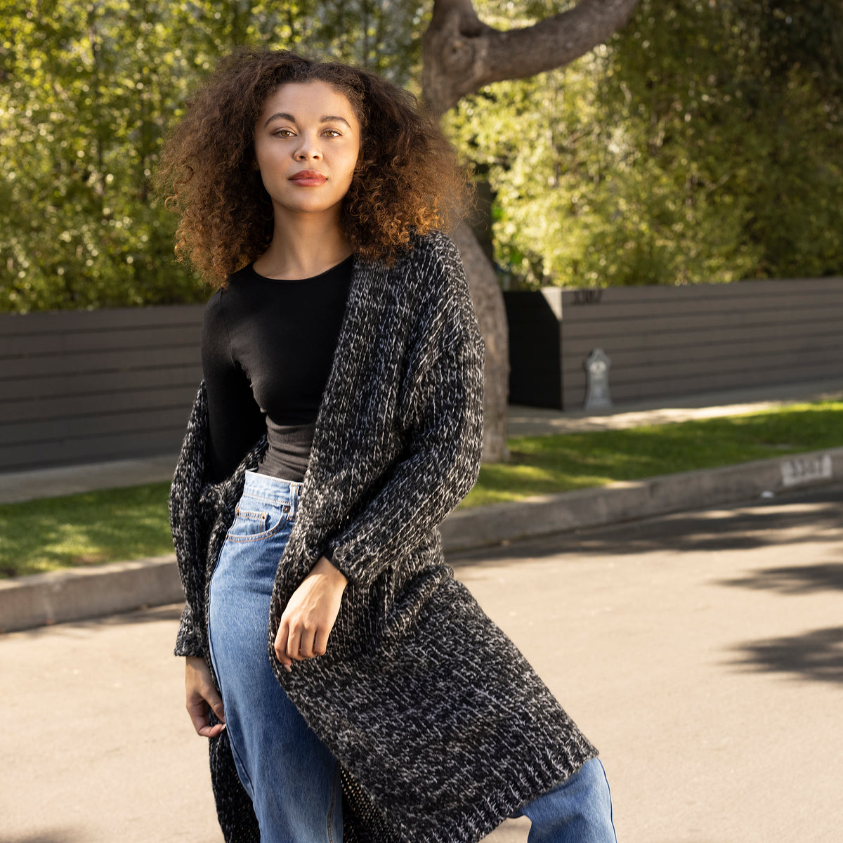 Black Marled Sweater Girl Outside Wearing Jeans and Long Sleeve Crewneck